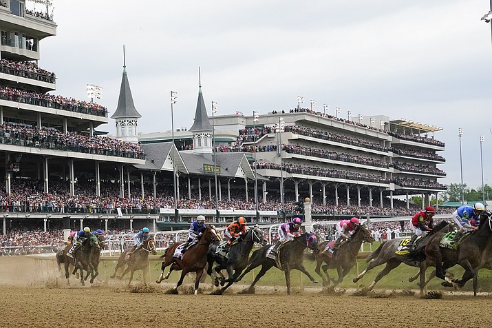 Javier Castellano, atop Mage, third from left, is seen behind with others behind the pack as they make the first turn while competing in the 149th running of the Kentucky Derby horse race at Churchill Downs Saturday, May 6, 2023, in Louisville, Ky. Churchill Downs will limit horses to four starts during a rolling eight-week period and impose ineligibility standards for continued poor performance in the wake of the recent deaths of 12 horses at the home of the Kentucky Derby. (Julio Cortez/AP, File)