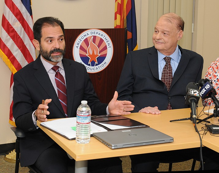 John Ward, an auditor at the Department of Education, explains Wednesday how and when he came up with the new estimate that vouchers will cost Arizona taxpayers $900 million next school year. With him is state schools chief Tom Horne. (Howard Fischer/Courtesy)