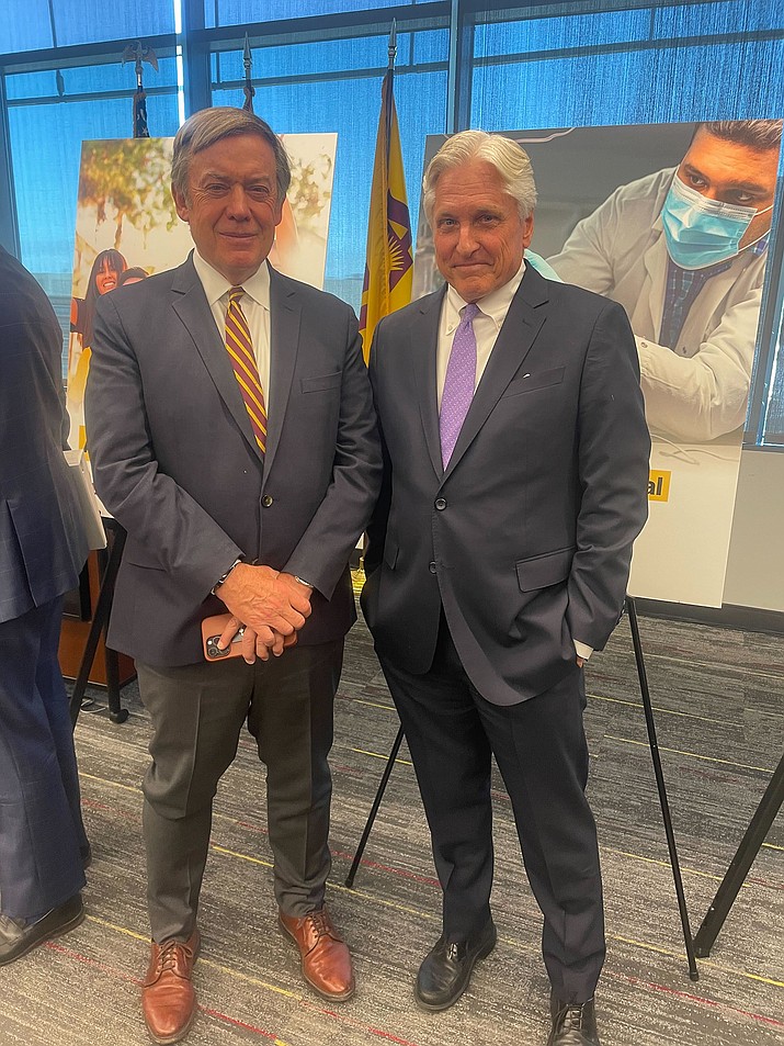 ASU President Michael Crow, left, and Fred DuVal, chair elect of the Arizona Board of Regents, confer after the regents meeting where Crow announced a new medical school on Thursday, June 1, 2023. (Sophia Biazus/Cronkite News)