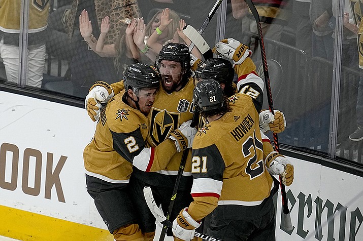 Vegas Golden Knights right wing Mark Stone, left, celebrates his goal against the Florida Panthers with Brett Howden (21), defenseman Zach Whitecloud (2) and center Chandler Stephenson during the third period of Game 1 of the NHL hockey Stanley Cup Finals, Saturday, June 3, 2023, in Las Vegas. (Abbie Parr/AP)