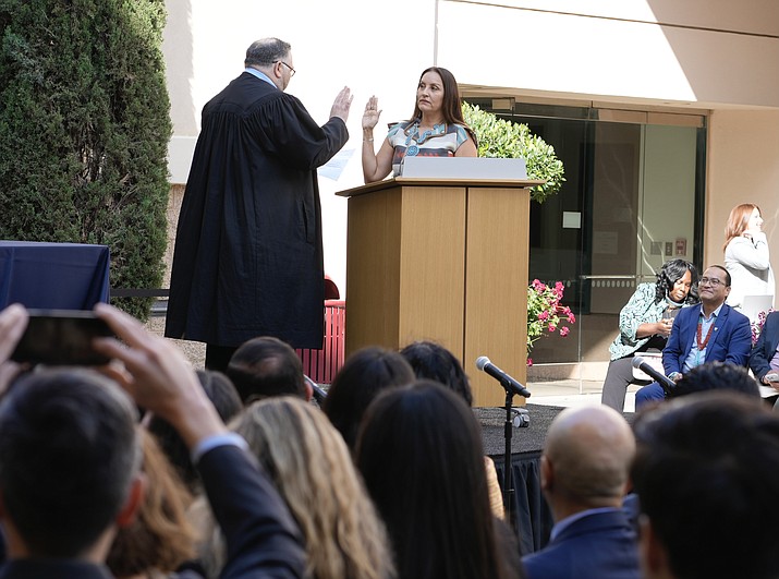 Sunshine Suzanne Sykes raises her right hand as she is sworn in as the federal district judge for the United States District Court for the Central District of California May 27 in Riverside, California. (Courtesy photo)