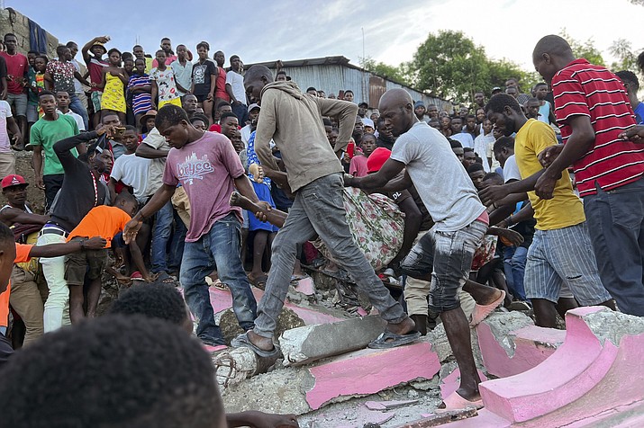 People carry an injured person away from a home that collapsed due to an earthquake in Jeremie, Haiti, Tuesday, June 6, 2023. (Ralph Simon/AP)