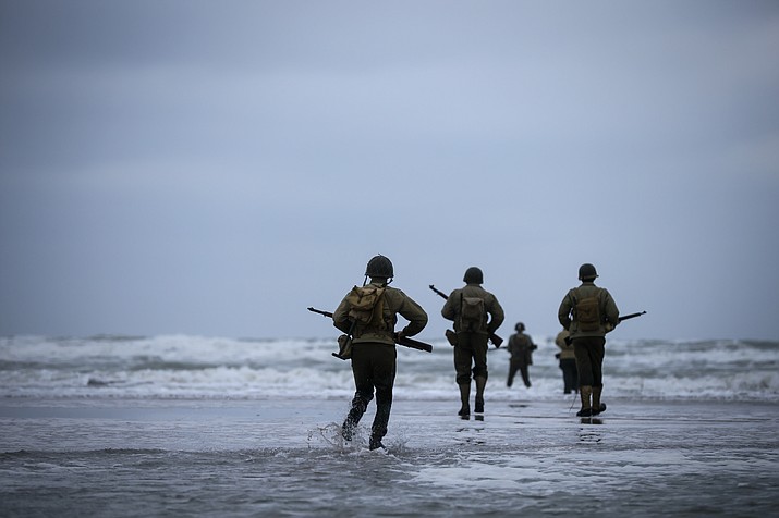 World War II reenactors walk on Omaha Beach in Saint-Laurent-sur-Mer, Normandy, France, Tuesday, June 6, 2023. The D-Day invasion that helped change the course of World War II was unprecedented in scale and audacity. Nearly 160,000 Allied troops landed on the shores of Normandy at dawn on June 6, 1944. (Thomas Padilla/AP)
