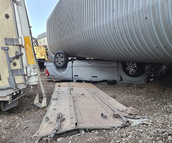 This image provided by the Coconino County Emergency Management shows a vehicle damaged as a result of a freight train derailment, Wednesday, June 7, 2023 east of Williams, Ariz. (Coconino County Emergency Management via AP)