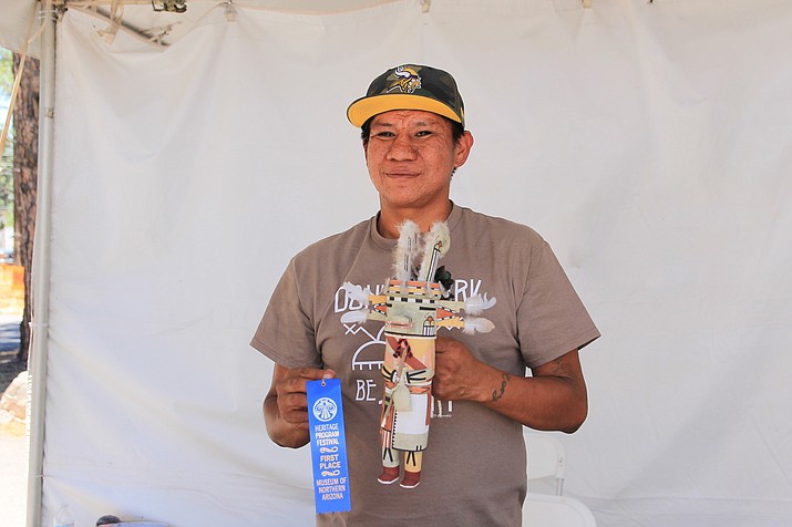 Cory Ahownewa poses with one of his kachinas and his first place ribbon from the Museum of Northern Arizona Heritage Festival.   (Wendy Howell/NHO)