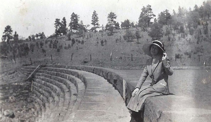 A woman stands in front of the  Santa Fe Dam circa 1920. (Photo/Messimer family)