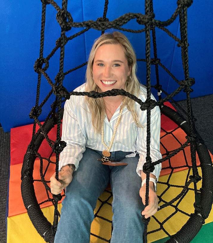Mile High Middle School special education teacher Mikaela Ball sits in the enclosed hammock chair in the multi-sensory room at her school. (Nanci Hutson/Courier)