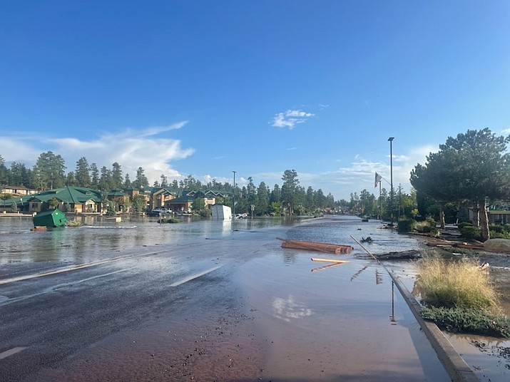 Water flows down State Route 64 in Tusayan the afternoon of Aug. 22. Construction equipment, dumpsters and even cars were seen floating in the makeshift river. (Photo/Grand Canyon National Park)