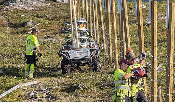 People work to build a new fence along the border with Russia, next to Storskog, Norway, Wednesday Aug. 23, 2023. Norway is re-building a section of fence in the Arctic along its border with Russia to contain wandering reindeer, Norwegian officials said Thursday, adding 42 animals have crossed into its eastern neighbor in a costly stroll this year. (HT Gjerde Finnmark via AP)