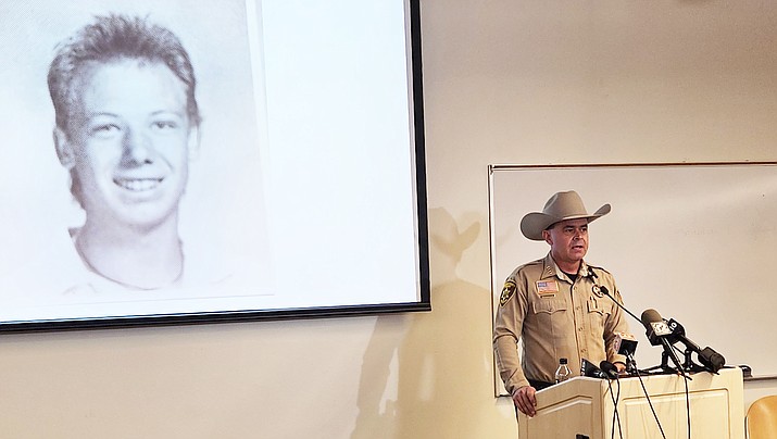 Yavapai County Sheriff David Rhodes, flanked by a high school photo of Bryan Scott Bennett, speaks at a press conference Friday, Aug. 25, 2023. Bennett has been linked to the 1987 murder of Cathy Sposito. (Debra Winters/Courier)