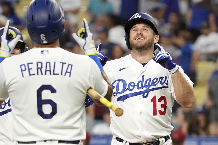 Los Angeles Dodgers' Max Muncy, right, is congratulated by David Peralta after hitting a two-run home run during the first inning of a baseball game against the Arizona Diamondbacks Monday, Aug. 28, 2023, in Los Angeles. (Mark J. Terrill/AP)