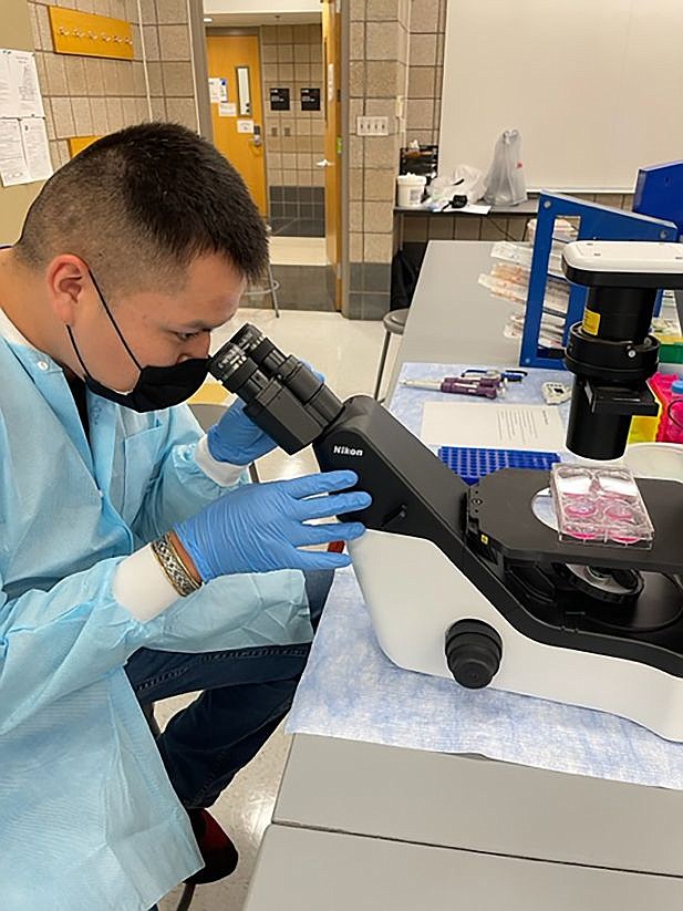 Isaac Silas examines a piece of tissue during his externship at the University of Minnesota. Silas is a graduate of Northland Pioneer College’s medical assistant program. (Photo/NPC)