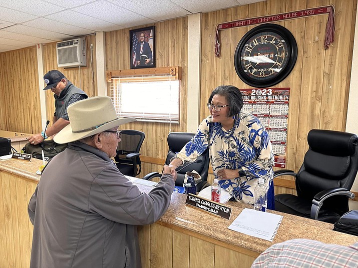 25th Navajo Nation Council Chairwoman of the Law and Order Committee shakes hands with a community member at the Tohatchi Chapter House.