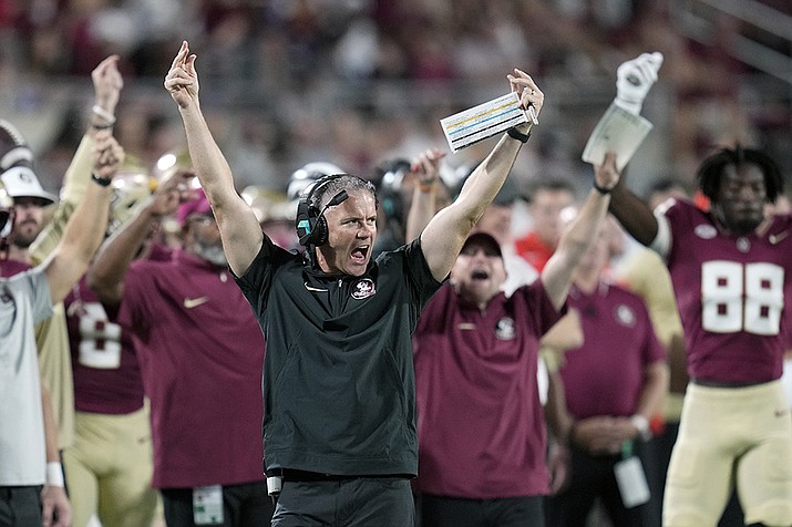 Florida State head coach Mike Norvell, center, reacts to players on the field after a timeout during the first half of an NCAA college football game against LSU, Sunday, Sept. 3, 2023, in Orlando, Fla. (AP Photo/John Raoux/AP)