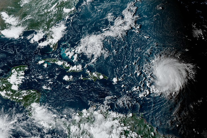 This satellite image provided by the National Oceanographic and Atmospheric Administration shows Hurricane Lee, right, in the Atlantic Ocean on Friday, Sept. 8, 2023, at 4:50 p.m. EDT. (NOAA via AP)