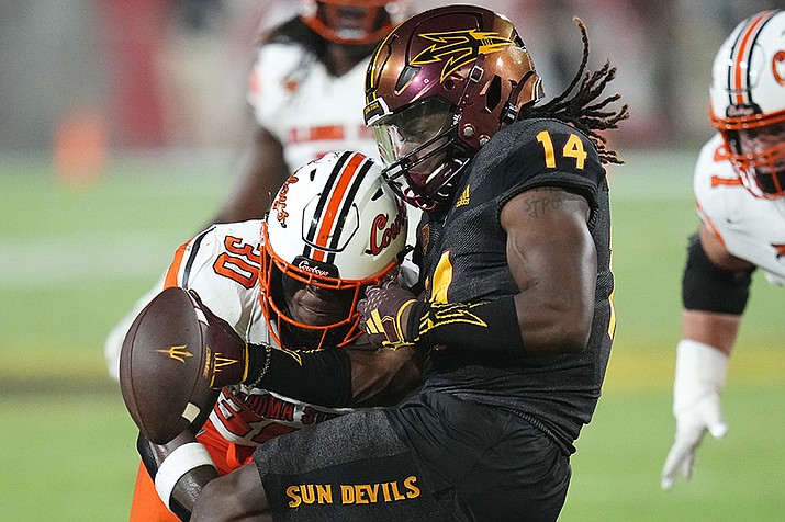 Oklahoma State linebacker Collin Oliver (30) forces a fumble as he knocks the ball loose from Arizona State running back Kyson Brown (14) during the first half of an NCAA college football game Saturday, Sept. 9, 2023, in Tempe, Ariz. Arizona State would recover the ball on the play. (Ross D. Franklin/AP)