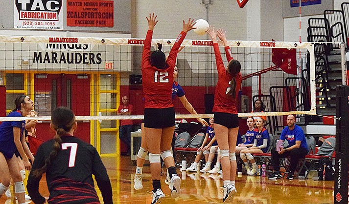Alice Kinsey (12) and Madi Smith (2) go for a block as Payton Budd (7) watches. (VVN/Paige Daniels)