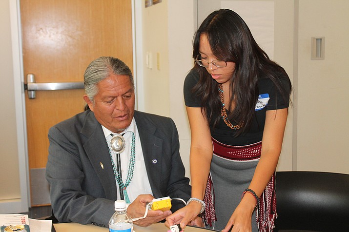 Anna helps Directer of Tribal Engagement Luther Lee with a hub at the KARMA event at NAU Aug. 26. (Alexandra Wittenberg/NHO)
