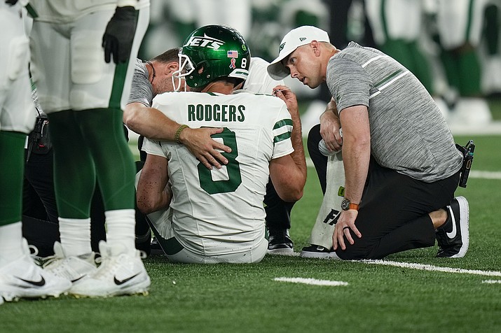 New York Jets quarterback Aaron Rodgers (8) is tended to on the field during the first quarter of a game against the Buffalo Bills, Monday, Sept. 11, 2023, in East Rutherford, N.J. (Seth Wenig/AP)