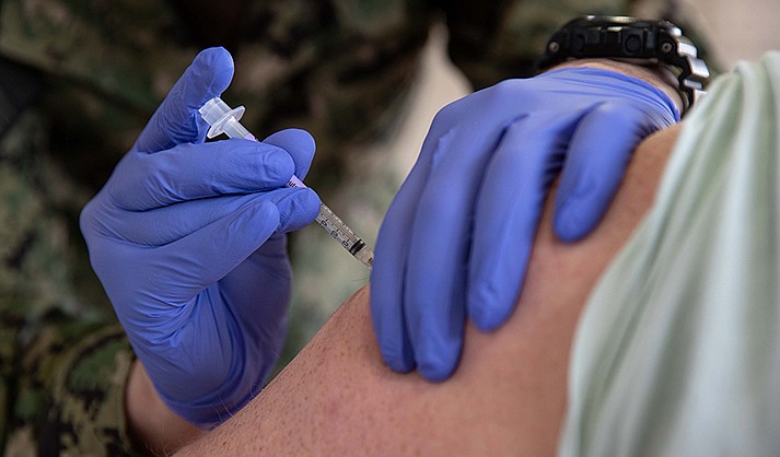 Federal officials approved an updated version of the COVID-19 vaccine, targeted for the latest coronavirus variant, as confirmed cases have been steadily climbing. In this file photos, a corpsman gives a COVID-19 vaccination at Naval Station Norfolk in April 2021. (Photo by Seaman Jackson Adkins/U.S. Navy)