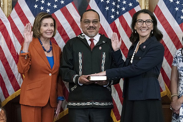 Speaker of the House Nancy Pelosi of Calif., left, administers the House oath of office to Rep. Mary Peltola, D-Alaska, standing next to her husband Eugene "Buzzy" Peltola Jr., center, during a ceremonial swearing-in on Capitol Hill in Washington, Tuesday, Sept. 13, 2022. Peltola's husband Eugene has died in an airplane crash in Alaska, her office said Wednesday, Sept. 13, 2023. (Jose Luis Magana/AP, File)