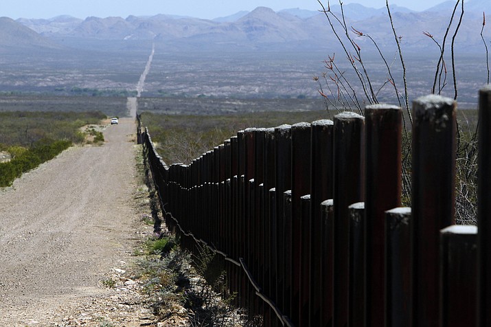 A U.S. Customs and Border Patrol truck, in the distance, patrols the U.S. border with Mexico, March 18, 2016, in Douglas, Ariz. The sheriff of Cochise County, Arizona's easternmost border county, asked state and federal officials for help Thursday, Sept. 14, 2023, with the sudden daily arrival of more than 100 migrants seeking asylum in the U.S., including families with small children. (Ricardo Arduengo/AP, File)