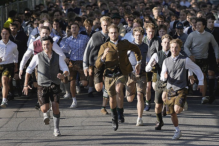 People run to enter the 188th 'Oktoberfest' beer festival in Munich, Germany, Saturday, Sept. 16, 2023. (Matthias Schrader/AP)