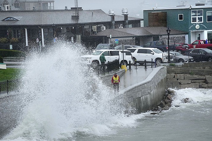 A city worker views a wave crashing along a walkway during storm Lee, Saturday, Sept. 16, 2023, in Bar Harbor, Maine. (Robert F. Bukaty/AP Photo)
