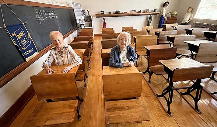 Helen Killebrew, 92, right, who started in second grade at the Clemenceau Public School, will be at the building’s 100th birthday celebration. Killebrew said children love to sit in the old-style desks. Barbara Evans, left, 91, will be leading the Pledge of Allegiance at the Anniversary party. (VVN/Vyto Starinskas)
