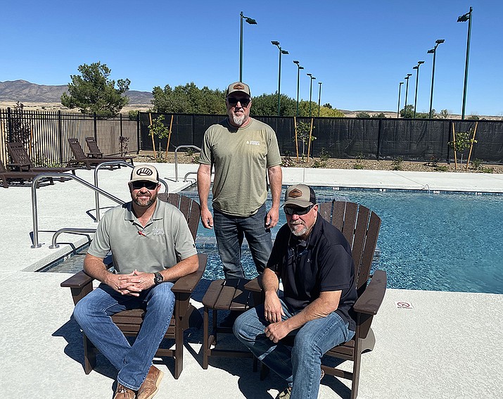 From left, Marc Van Wormer, Kevin Lollar, standing, and Mike Middleton are partners, among others, in Desert Pines Resort – a 55-plus manufactured home community near Fain Road and Highway 69 in Dewey. The resort’s amenities include a swimming pool and pickleball courts. (Tim Wiederaenders/Courier)