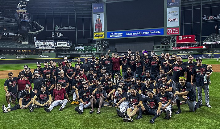 The Arizona Diamondbacks pose for a picture after Game 2 of their National League wildcard baseball series against the Milwaukee Brewers Wednesday, Oct. 4, 2023, in Milwaukee. The Diamondbacks won 5-2 to win the series. (AP Photo/Morry Gash)