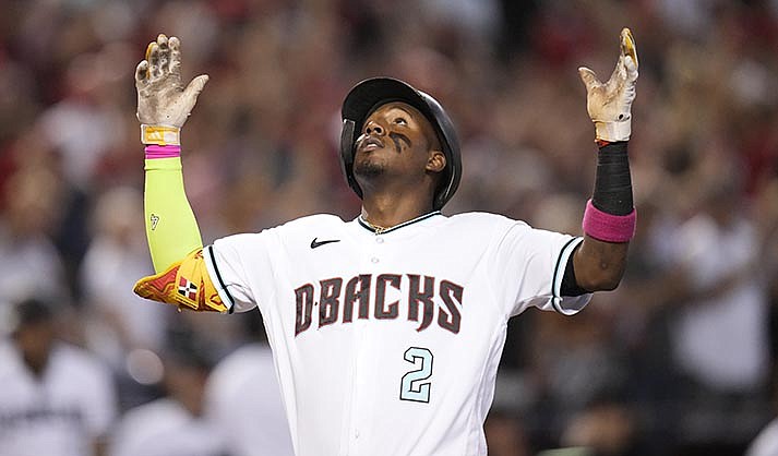 Arizona Diamondbacks' Geraldo Perdomo celebrates after hitting a home run during the third inning in Game 3 of a baseball NL Division Series against the Los Angeles Dodgers, Wednesday, Oct. 11, 2023, in Phoenix. (AP Photo/Ross D. Franklin)