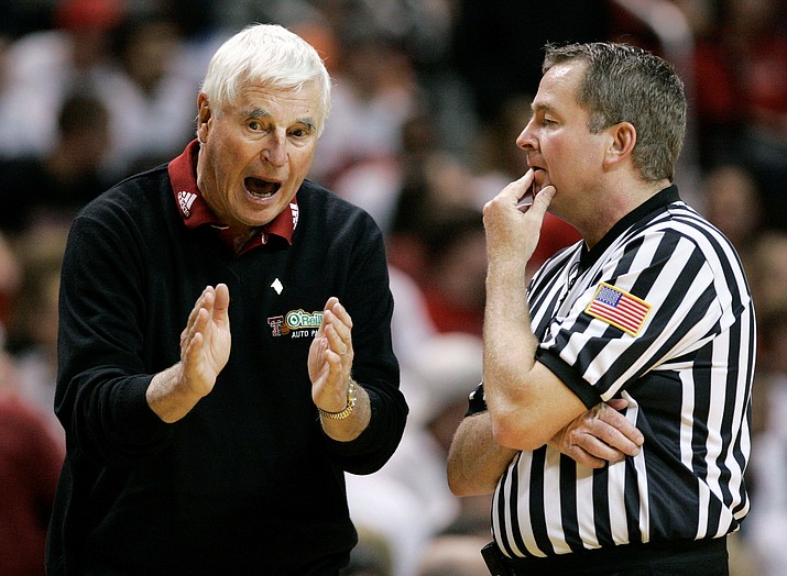 Texas Tech coach Bob Knight, left, argues a call with an NCAA official during a basketball game against Texas A&M in Lubbock, Texas, Wednesday, Jan. 16, 2008. Knight earned his 900th career win in the 68-53 win over Texas A&M. Bob Knight, the brilliant and combustible coach who won three NCAA titles at Indiana and for years was the scowling face of college basketball has died. He was 83. Knight's family made the announcement on social media Wednesday evening, Nov. 1, 2023. (Tony Gutierrez/AP-File)