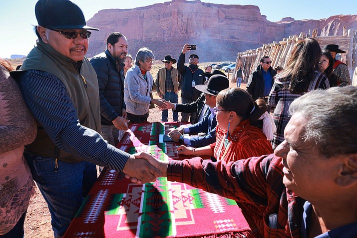 President Buu Nygren and Speaker Crystalyne Curley joined Council Delegate Herman Daniels Jr., Oljato Chapter President Willis Begay and representatives of Goulding’s Trading Post sat before a tsé bee hoogan, a Navajo female hogan, during the signing of the purchase of Goulding’s Lodge. (Photo/OPVP)