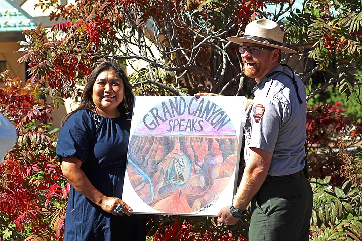 Diné artist Janet Yazzie and ranger Daniel Pawlak hold the logo Yazzie designed for the Grand Canyon’s new podcast outside the Grand Canyon Conservancy in October.  (Alexandra Wittenberg/ NHO)