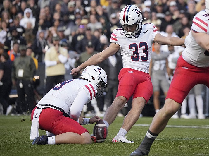 Arizona place kicker Tyler Loop (33) connects for the winning field goal as Jackson Holman holds the ball in the second half of an NCAA college football game against Colorado on Saturday, Nov. 11, 2023, in Boulder, Colo. (David Zalubowski/AP)