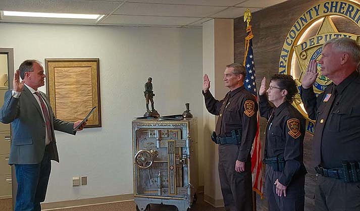 Randall Duncan of Prescott Valley, Helen Graham of Black Canyon City and Chris Hartman of the Village of Oak Creek are sworn in as Volunteers in Protection. (Courtesy photo from YCSO)