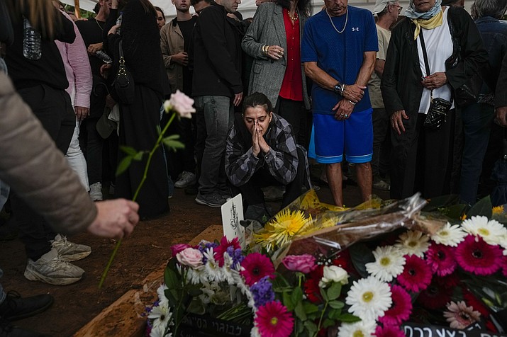Mourners gather around the grave of Israeli reserve soldier Master sergeant Raz Abulafia at the end of his funeral in the village of Rishpon, Israel, Tuesday, Nov. 14, 2023. Abulafia, 27, was killed during a military ground operation in the Gaza Strip. (Ariel Schalit/AP)