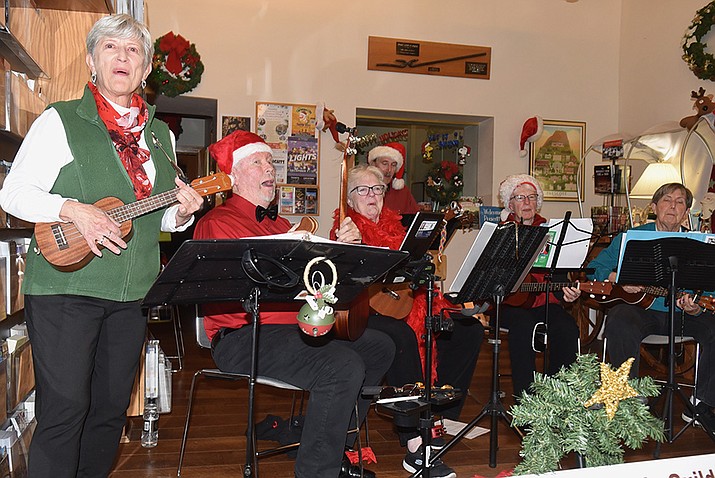 The Prescott Ukulele Guild performs at Acker Night, an annual holiday event that benefits local children’s arts programs, on Friday, Dec. 8, 2023. The event featured local and national musical talent, fostering a night of music, food and fun during the holiday season. Donation “Tips for Scholarships” bags were placed in front of performers, with proceeds supporting Yavapai County school children’s music lessons and aiding the local school district’s music department. For a photo gallery of the festivities, visit dCourier.com. (Jesse Bertel/Courier)