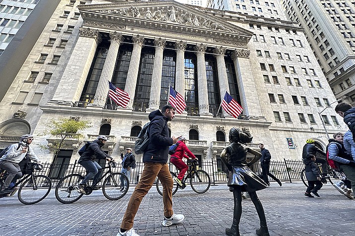 A man passes the "Fearless Girl" statue in front of the New York Stock Exchange in New York on Friday, November 3, 2023. (Ted Shaffrey/AP)