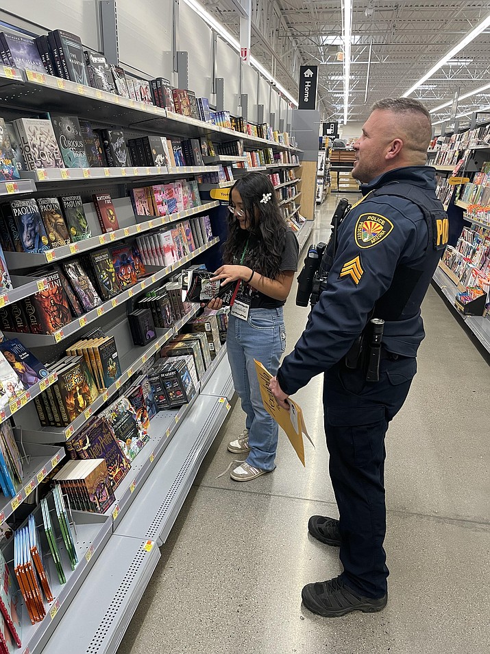Officer Mark Parker of the Prescott Police Department shops with Aerabella at the Walmart on Highway 69 Saturday, Dec. 9, 2023. (Jim Wright/Courier)