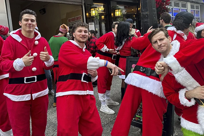 Revelers take part in the annual SantaCon charity pub crawl on Saturday, Dec. 9, 2023 in New York. Thousands of people dressed as jolly Old St. Nick have descended on New York City that kicked off early Saturday morning in bars in midtown Manhattan. (Andrew Meldrum/AP)