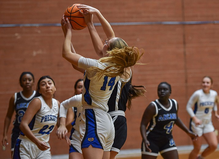 Sophomore point guard Emmalynn Little goes up for a rebound against an Arcadia Titans player during the first game of the Prescott Lady Badger Winter Classic. (Matt Wilson/For the Courier)