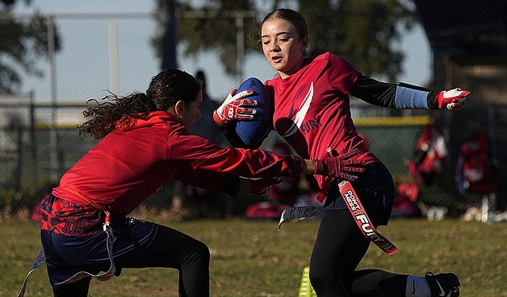 Paulina Haefeli Casillas, left, reaches for the flag of Isabella De Felice, right, during a practice with Texas Fury, an all-girls flag football select travel team,Sunday, Dec. 10, 2023, in Austin, Texas. Flag football's inclusion in the 2028 Summer Olympics in Los Angeles only enhances the profile of a sport that's growing by leaps and bounds on the women's side. (AP Photo/Eric Gay)