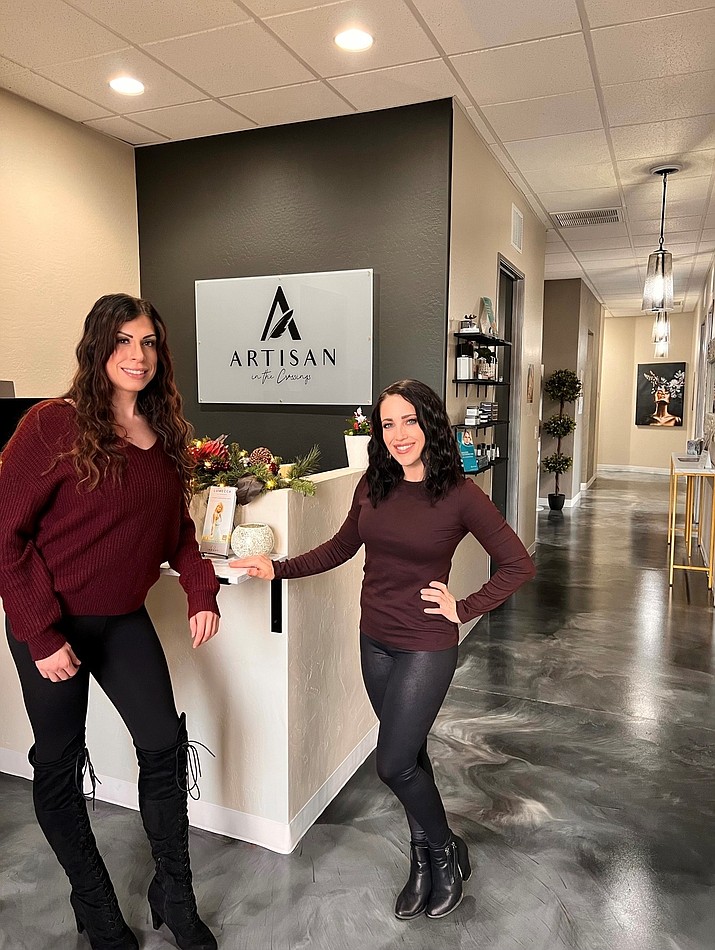 Jennifer O’Neill (right) stands with aesthetician Gina Gallerani in front of the company logo. (Courtesy photo)