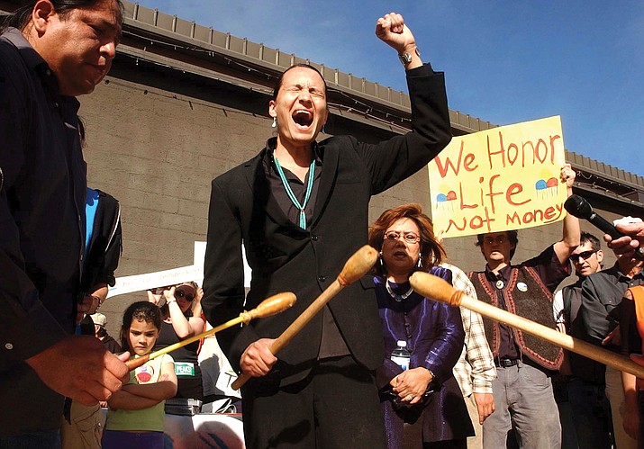 Klee Benally, a member of the Save the Peaks Coalition, sings an American Indian movement song, during a news conference held March 8, 2005, in Flagstaff, Ariz. Benally, advocated on behalf of Indigenous people and environmental causes, died Dec. 30. (Jill Torrance/Arizona Daily Sun via AP, File)