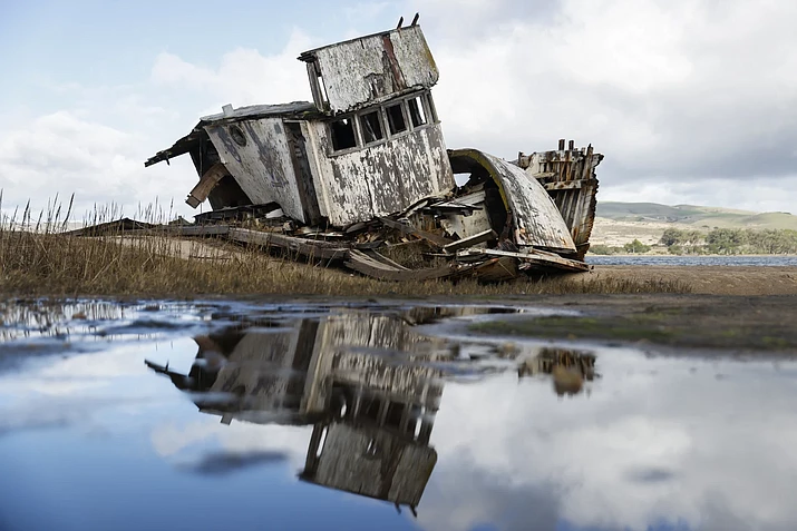 The “Inverness Shipwreck” sis in disarray on the shores of Tomales Bay in Inverness, Calif. Wednesday, Jan. 3, 2024. Time is apparently running out for the old wooden boat that became an Instagram star as it rotted on a shoreline north of San Francisco. (Jessica Christian/San Francisco Chronicle via AP)