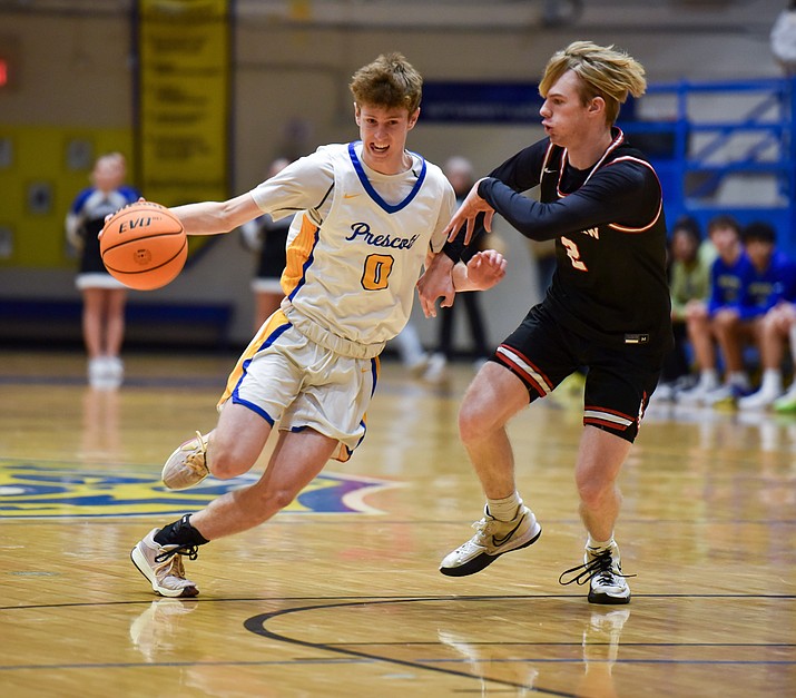 Prescott's Cooper Magnett (0) drives the ball past Bradshaw Mountain's Preston  Ranniker (2) during the high school rivarly game that took place on Jan. 8, 2024, at Prescott High School. Prescott won the game 55-40. (Matt Wilson/For the Courier)