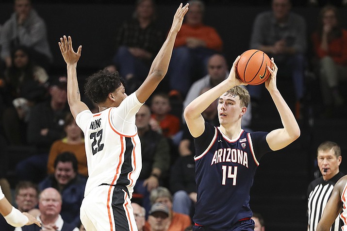 Arizona center Motiejus Krivas (14) looks to pass the ball as Oregon State forward Thomas Ndong (22) defends during the first half of an NCAA college basketball game Thursday, Jan. 25, 2024, in Corvallis, Ore. (Amanda Loman/AP)
