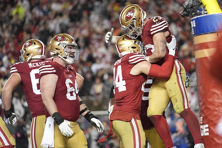San Francisco 49ers running back Christian McCaffrey, right, celebrates his rushing touchdown with teammates during the second half of an NFL football NFC divisional playoff game against the Green Bay Packers Saturday, Jan. 20, 2024, in Santa Clara, Calif. (Ashley Landis/AP)